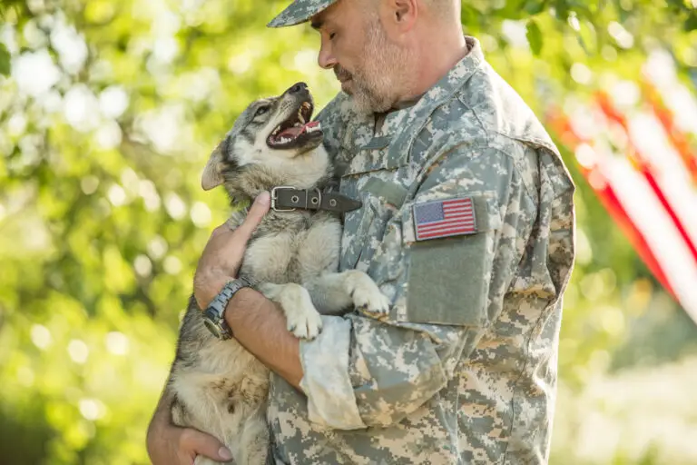 Veteran Holding Dog in Holistic addiction treatment
